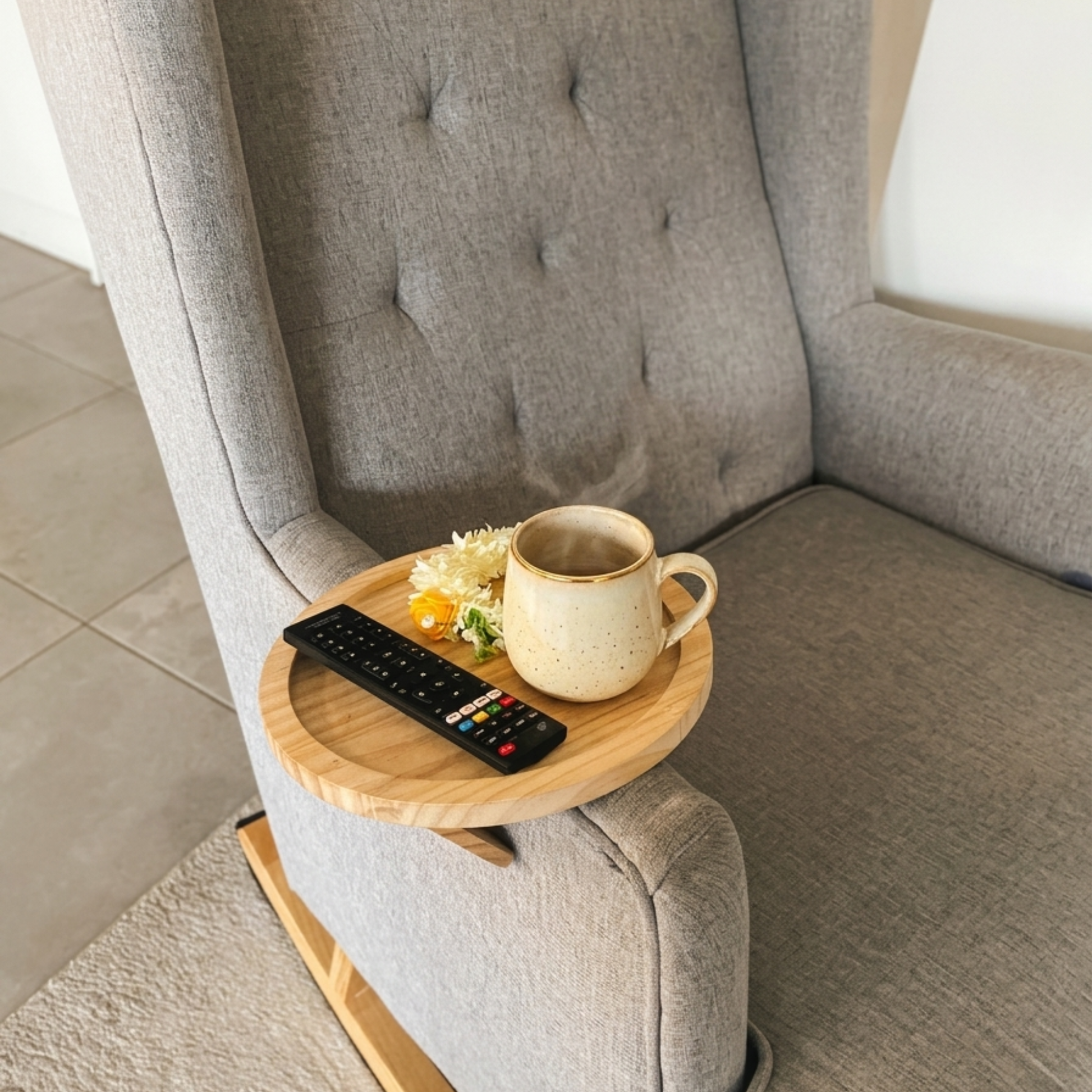 Striveira clip-on sofa tray on grey armchair with coffee mug and remote control